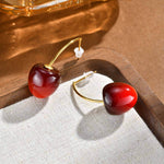 Puces d’oreilles cerise rouge en acier inoxydable