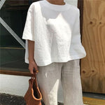 Blouse ample à col rond et manches trois-quarts — coupe trapèze