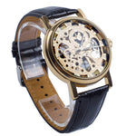 Montre mécanique squelette dorée à bracelet cuir noir