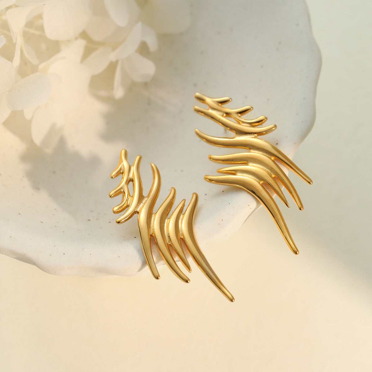 Boucles d'oreilles grimpantes aile stylisée