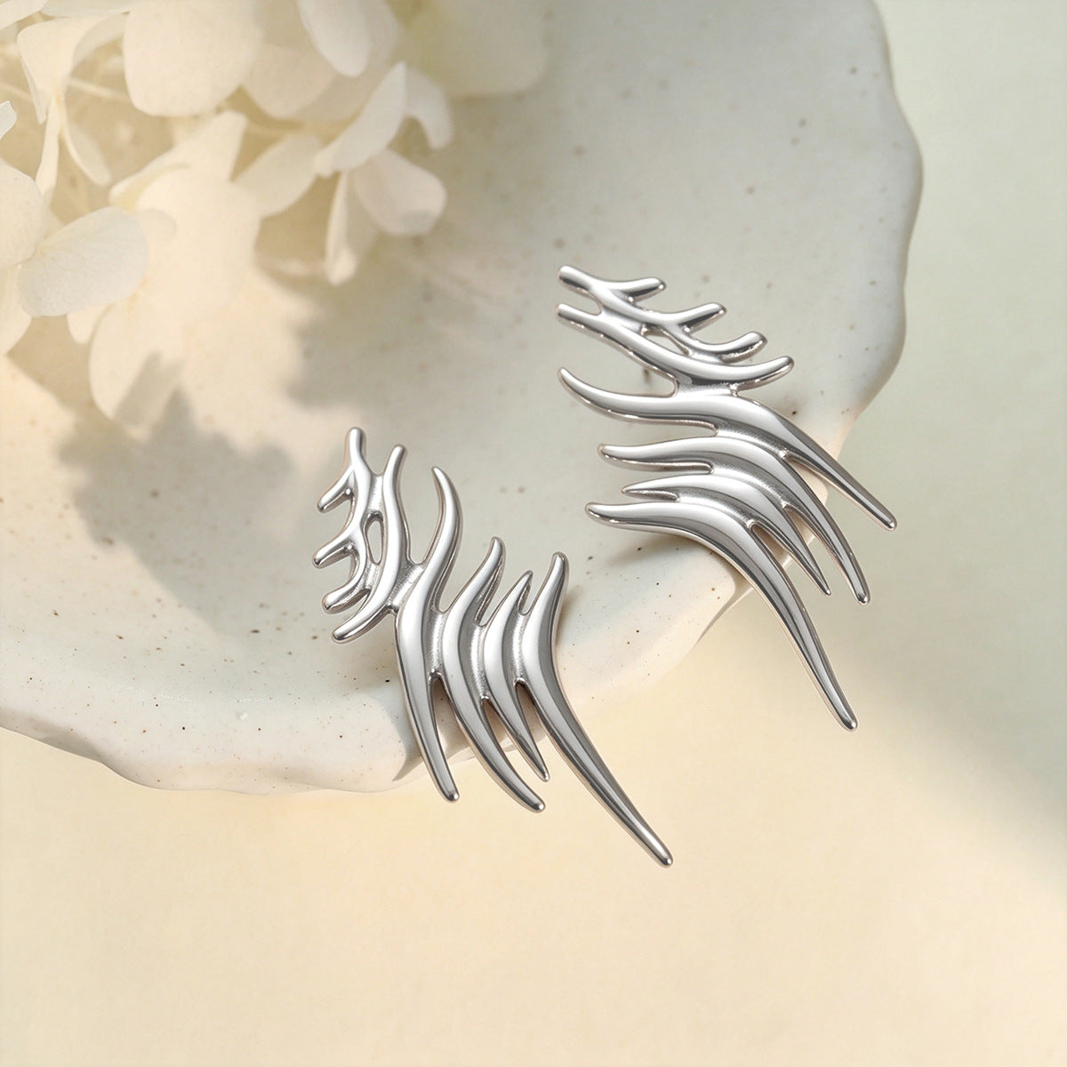 Boucles d'oreilles grimpantes aile stylisée