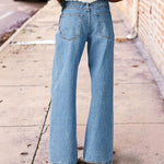 Pantalon large en denim délavé à broderie fleurie
