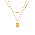 Collier double rang doré à médaillon ovale gravé d’une étoile