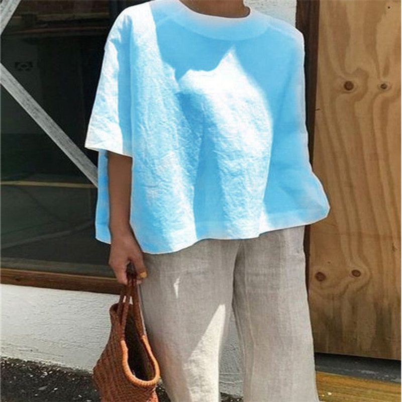 Blusa amplia de cuello redondo y manga tres cuartos — corte trapecio — color