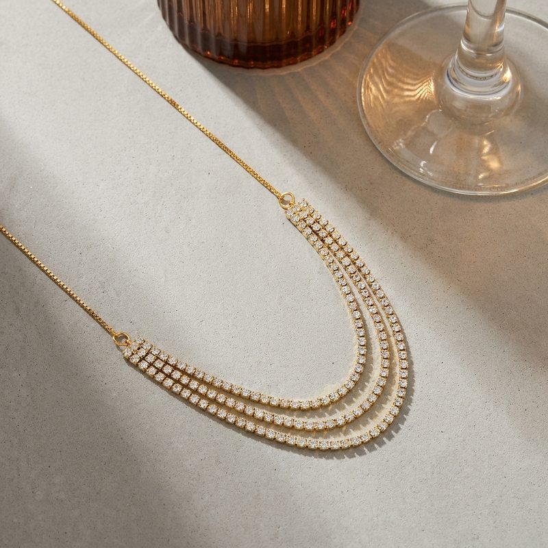Collier rivière triple rang serti de zircons — doré